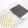 A white box shows a grid of prewound bobbins and a pile of white bobbins for home embroidery machines.