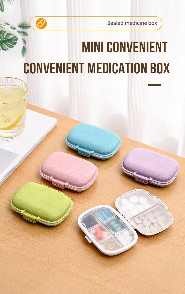A collection of mini convenient medication boxes in various pastel colors and a clear compartment organizer are displayed on 