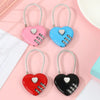Three heart-shaped combination padlocks in pink, blue, and black for luggage and storage
