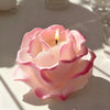 A pink rose-shaped silicone mold for crafting candles, soap, and resin