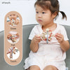 A baby is shown interacting with a silicone sensory rattle ball, demonstrating gnaw, pull, and touch sensations.