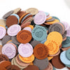 A collection of round, handmade PU leather labels in various earthy and pastel colors for DIY crafts.