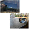 Close-up view of a car mirror covered in water droplets, demonstrating rain-proof film protection.