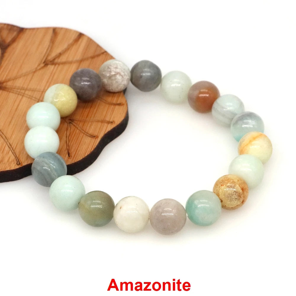 A beaded bracelet made of Amazonite stones is displayed on a wooden surface.
