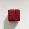 A square, glossy red metal fidget spinner cube for stress relief.