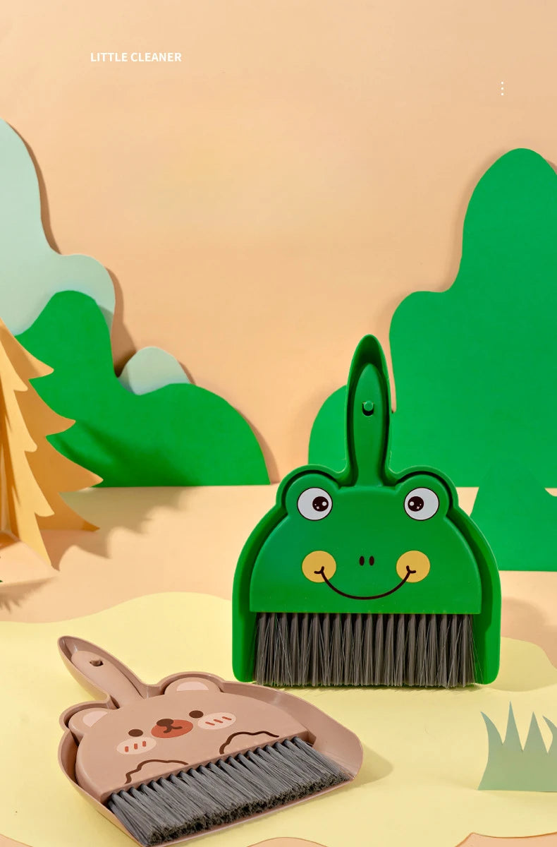 A green cartoon broom and dustpan set with a cute face is shown on a light background.