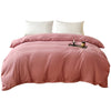 A pink washed cotton brushed duvet cover with white pillows on a bed.