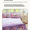 A purple floral print bed skirt and pillowcase set displayed on a bed with white nightstands.