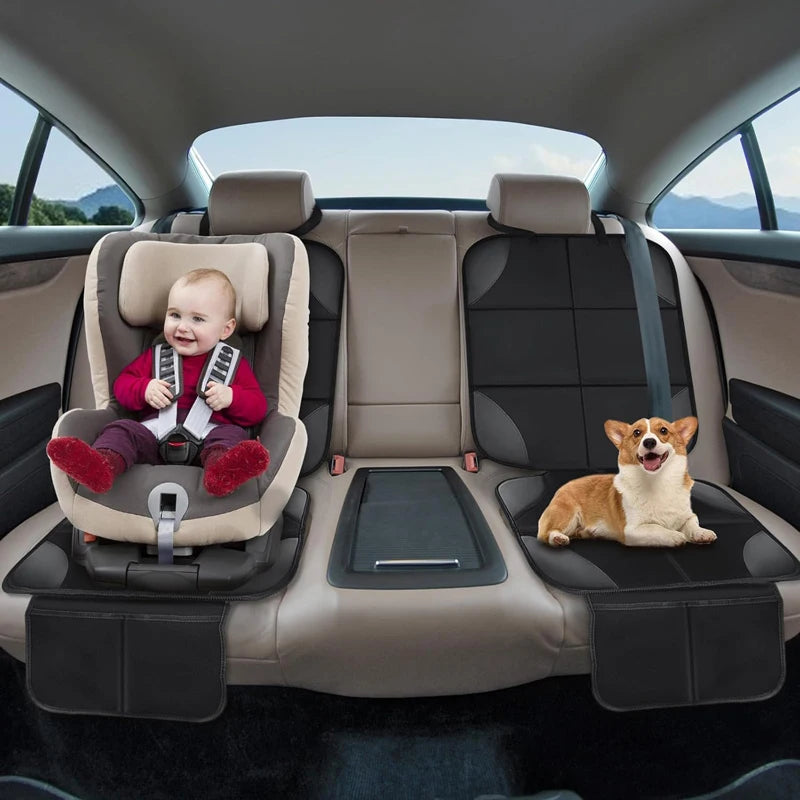 A dog rests on a seat in a car with a baby seated in a car seat protector.