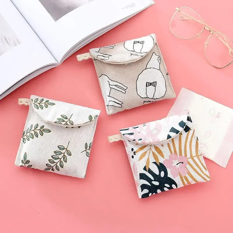 A collection of fabric cosmetic storage pouches featuring various floral and line art patterns on a pink background.