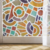 A close-up of frosted stripe privacy window film featuring an abstract geometric pattern in earthy tones.