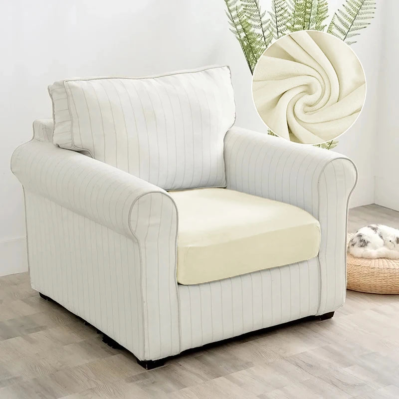 A cream-colored plush velvet stretch sofa seat cover with vertical stripes sits on a light wood floor.