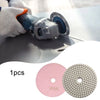 A hand is using a diamond polishing pad on a piece of stone or concrete, with two circular pads shown below.