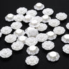 A collection of 100 white acrylic pearl spacer beads arranged on a dark surface.