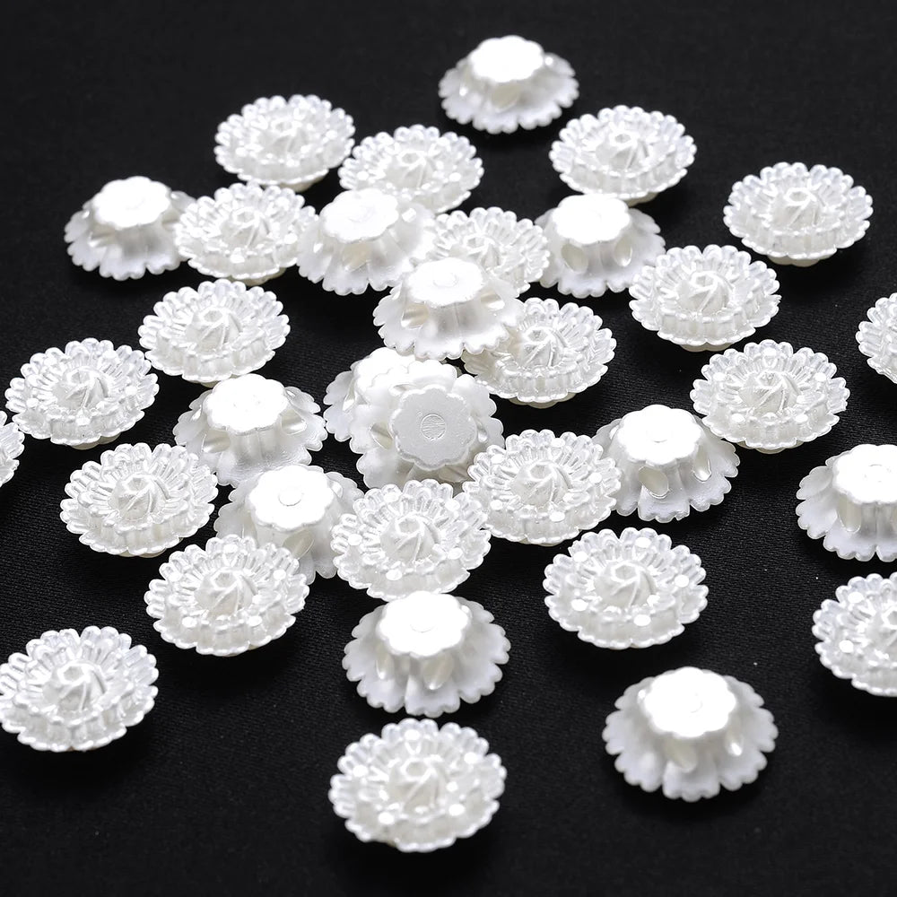 A collection of 100 white acrylic pearl spacer beads arranged on a dark surface.