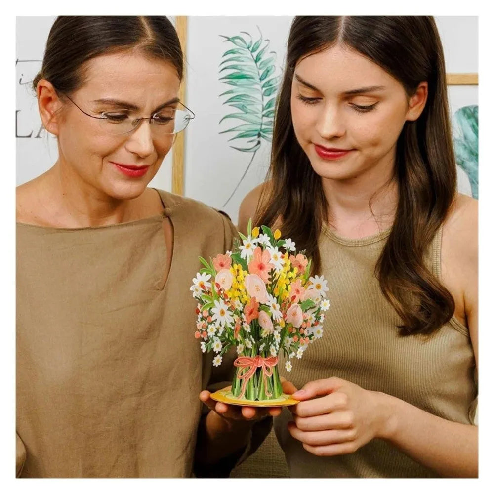 A woman holds a colorful bouquet of cherry blossoms and greenery.