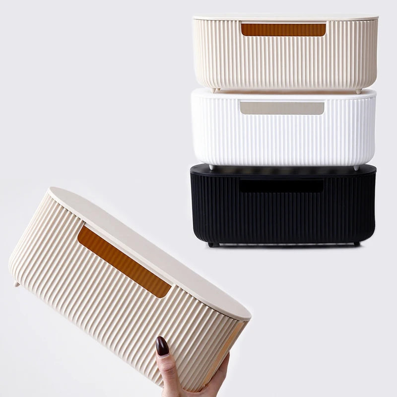 A white cable management box with a wooden accent is shown being held, next to two other similar boxes.