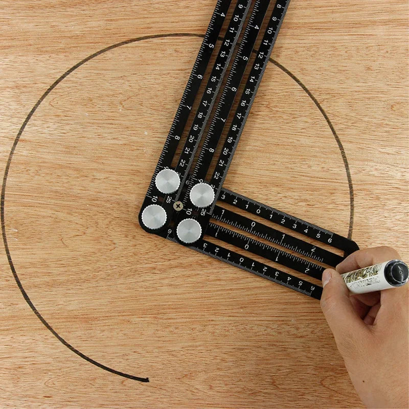 A hand holds a foldable aluminum angle ruler with locking segments, demonstrating its measurement capabilities on a wooden su