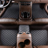 Interior view of a car with brown leather floor mats and wood trim visible on the dashboard and seats.