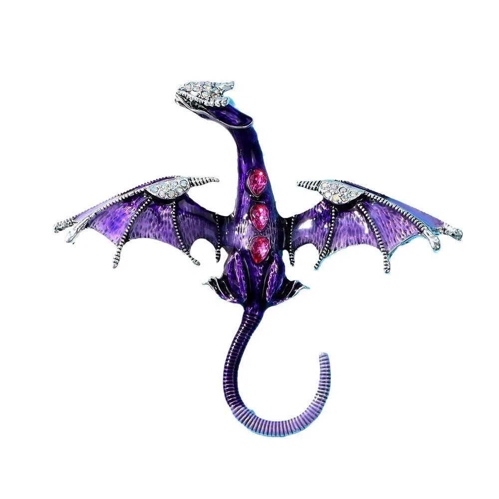 A purple enamel dragon brooch featuring rhinestone accents and wings.