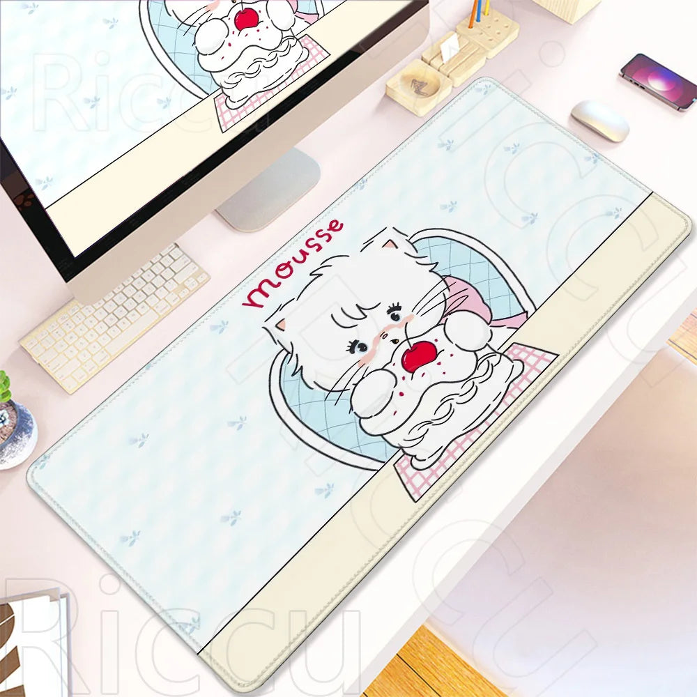 A white and pink kawaii cartoon cat design on a gaming desk mat with a non-slip rubber base.