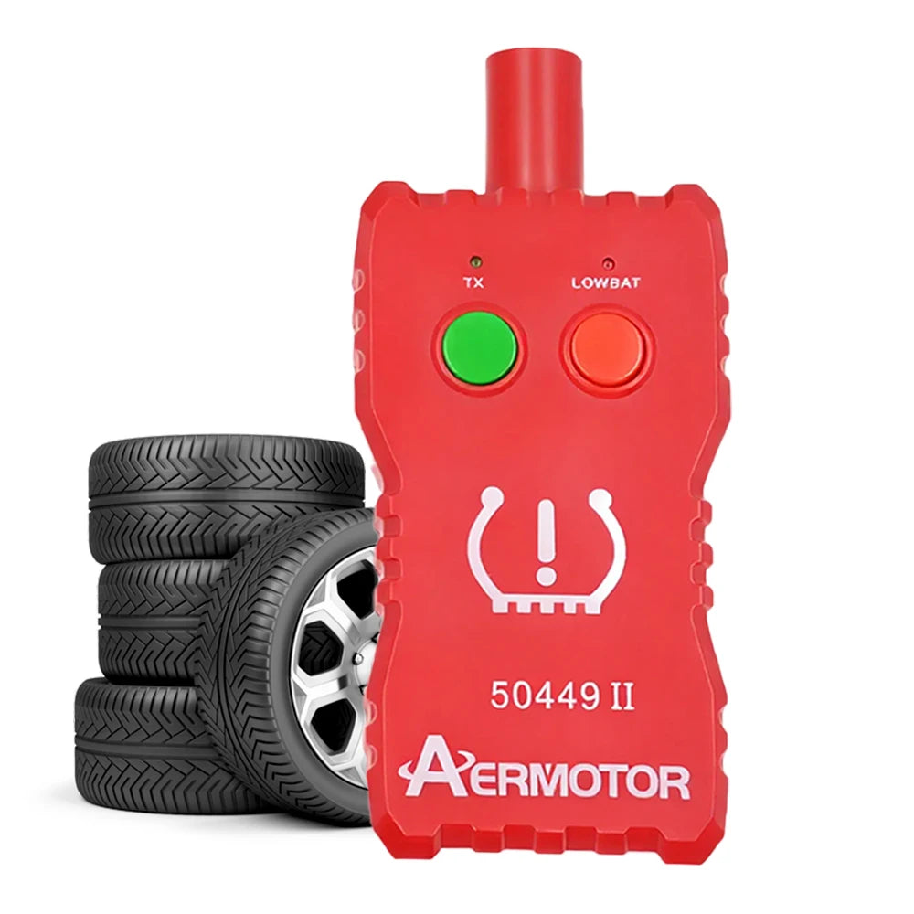 A red 2-in-1 TPMS relearn tool with TX and LOWBAT indicators lying next to a stack of tires.