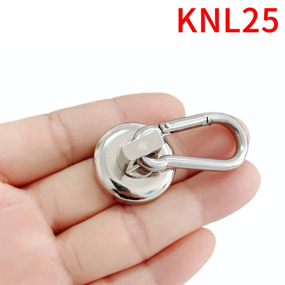 A hand holds a silver heavy duty neodymium magnetic hook with a swivel carabiner.