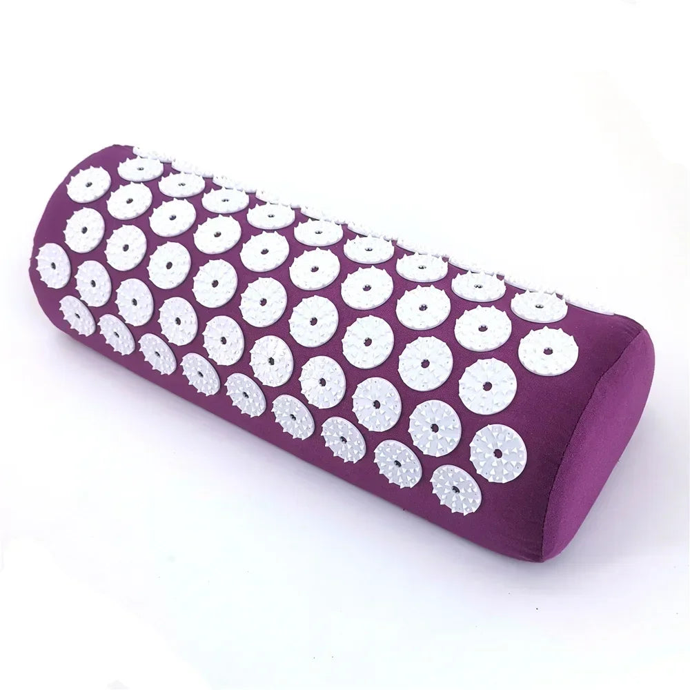 A purple acupressure mat and pillow set covered in white studs for pain relief and relaxation.