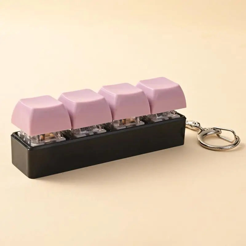 A black keychain featuring pink LED mechanical fidget toy keycaps.