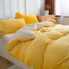 A bright yellow cozy flannel duvet cover with a zipper displayed on a bed.
