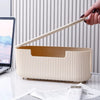 A hand holds a light beige cable management box organizer for desk and home use.