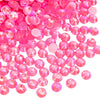 A pile of bright pink and clear rhinestones for DIY crafts and clothing decoration