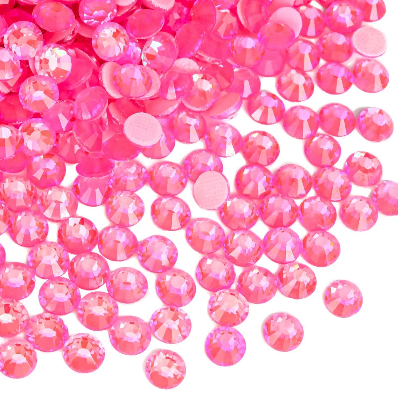 A pile of bright pink and clear rhinestones for DIY crafts and clothing decoration