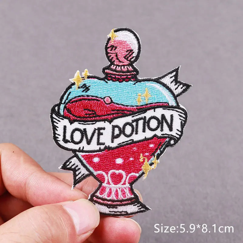 An embroidered patch featuring a skull with a glowing eye and the text LOVE POTION on a fabric background.