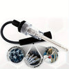 Automotive spark plug ignition tester with diagnostic gauge shown connected to a black handle and wire.