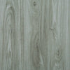 Close-up view of gray wood grain vinyl flooring tiles with visible natural texture and linear patterns.