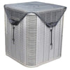 A silver outdoor AC unit is covered with a breathable black mesh protective cover.