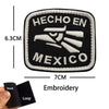 Black embroidered patch featuring the text HECHO EN MEXICO and an eagle skull design with hook and loop backing.