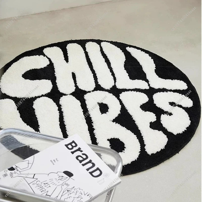 A round black carpet with white lettering spelling out CHILL LUBES