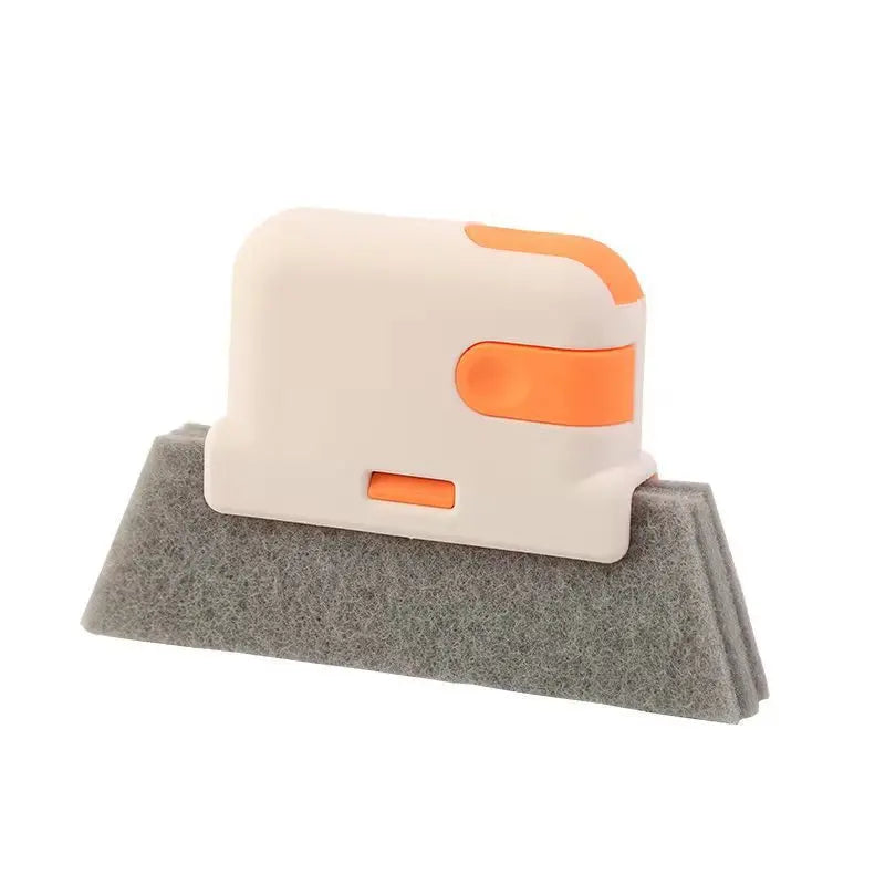 A white and orange multi-purpose crevice cleaning brush resting on a gray felt surface.