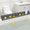A flexible silicone sink splash guard with a suction base holding small yellow and white toys in a bathroom sink.