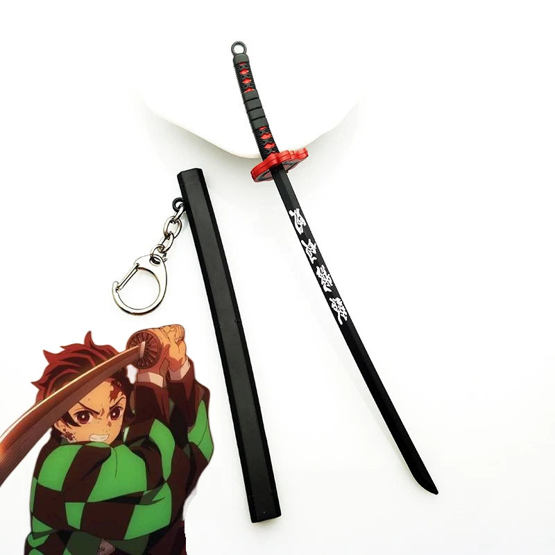 A replica Demon Slayer mini katana sword with a black handle and red guard, next to an anime figure.
