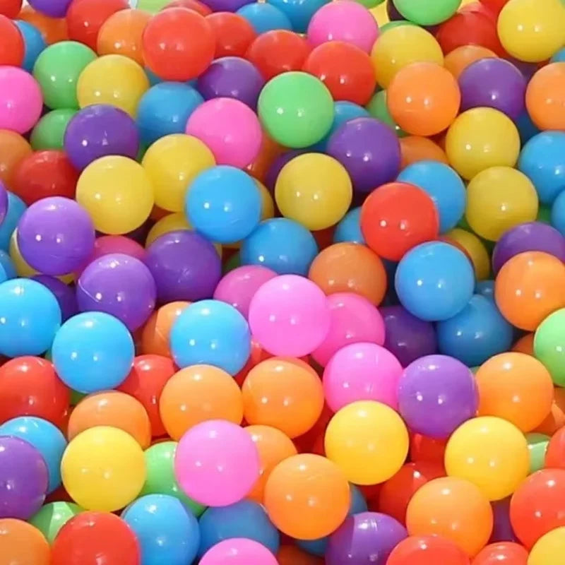 A pile of colorful non-toxic ball pit balls for kids in various bright colors.