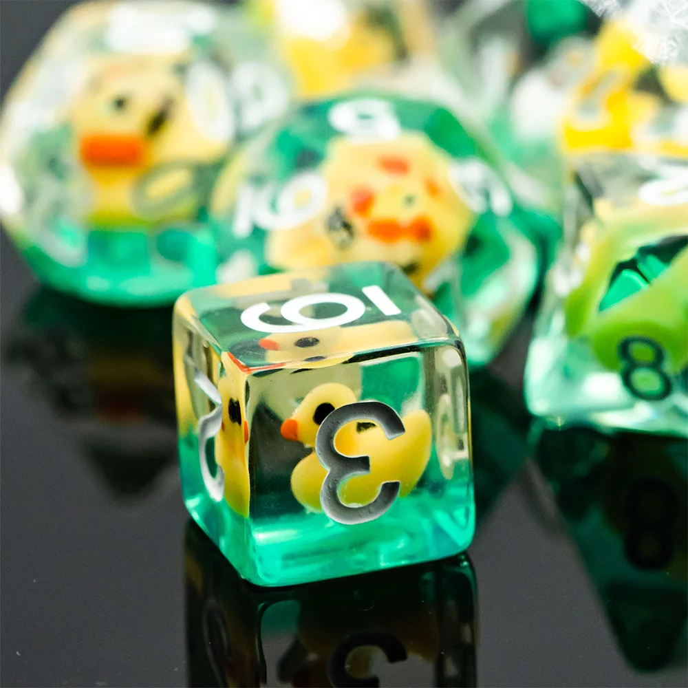 A close-up of a set of green resin dice featuring yellow animal figures used for RPG adventures.