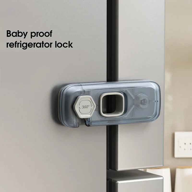 A baby proof refrigerator lock installed on a silver appliance door.