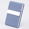 A blue woven card holder with a white leather sleeve and stainless steel closure.