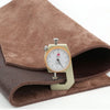 A dark brown leather fabric sleeve with a brass measuring tool inside.