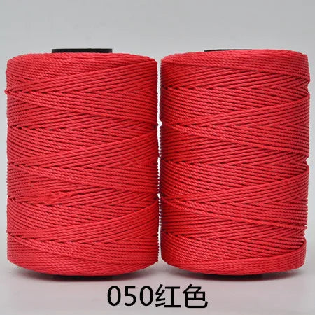Two spools of red 3-ply polyester knitting yarn for crochet and hand crafts