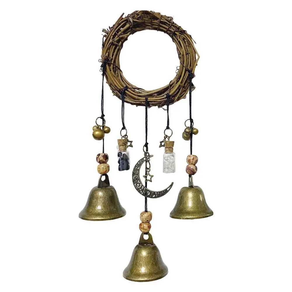 A rustic wreath made of twigs with several hanging brass bells and charms.