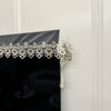 Black table runner featuring intricate silver embroidered mesh lace with dangling pendants